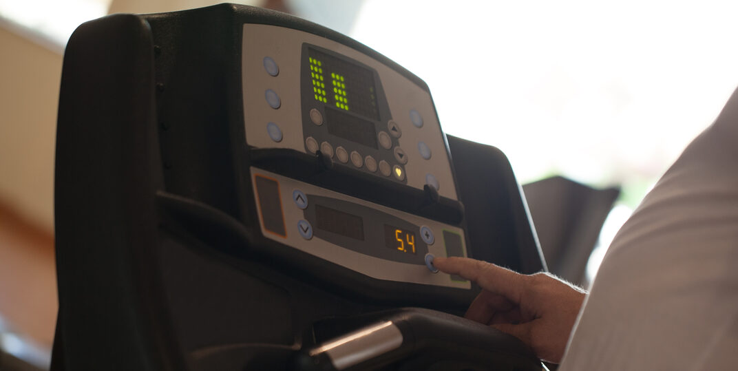 Man on Treadmill using the touch screen