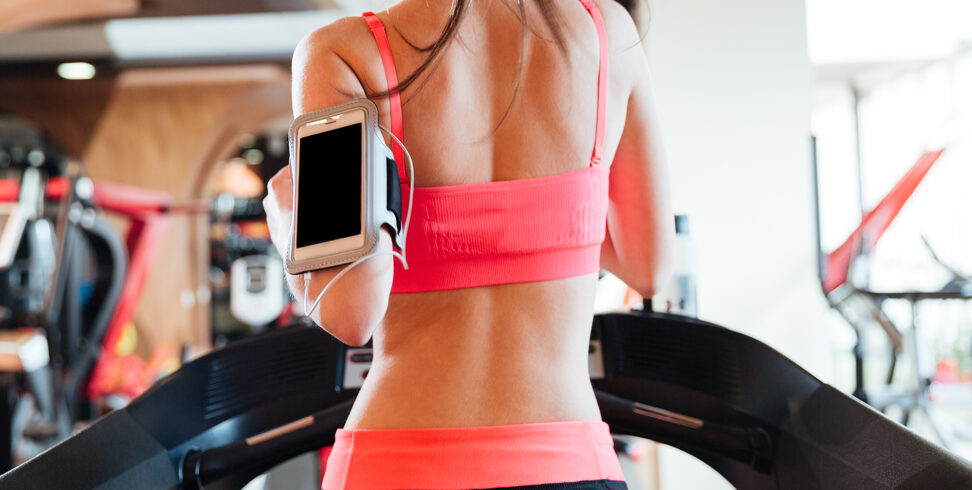 Young Woman on Treadmill with iPod