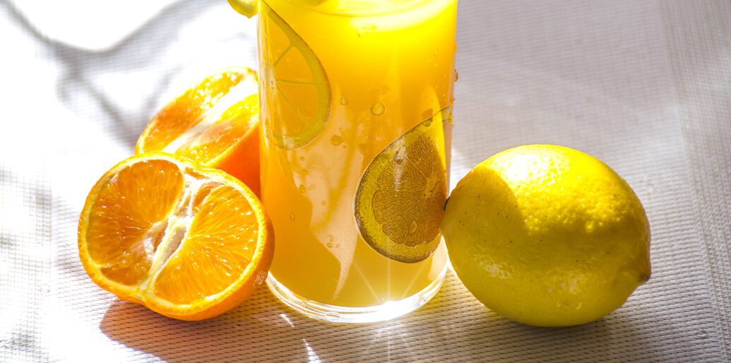 Glass of Orange with Oranges and Lemons